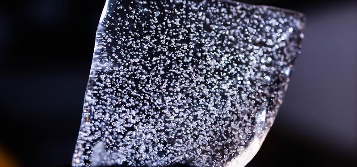 Up close image of slice of Antarctic ice core that shows air bubbles containing ancient gasses