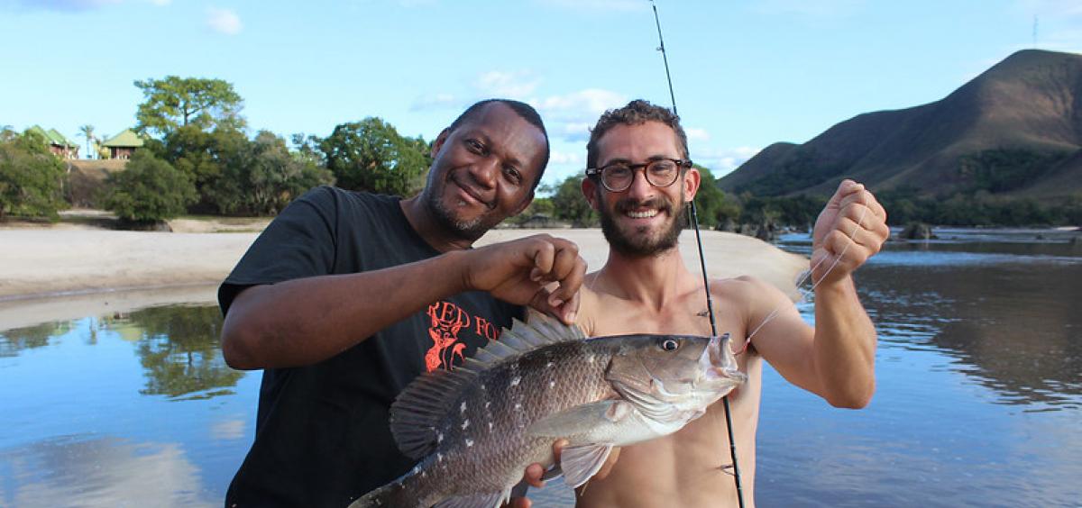 Researcher Joe Cutler (right) poses with a Guinea snapper he collected at Lope National Park in Gabon. This fish was collected farther upstream than any other marine-associated fishes. in Gabon.