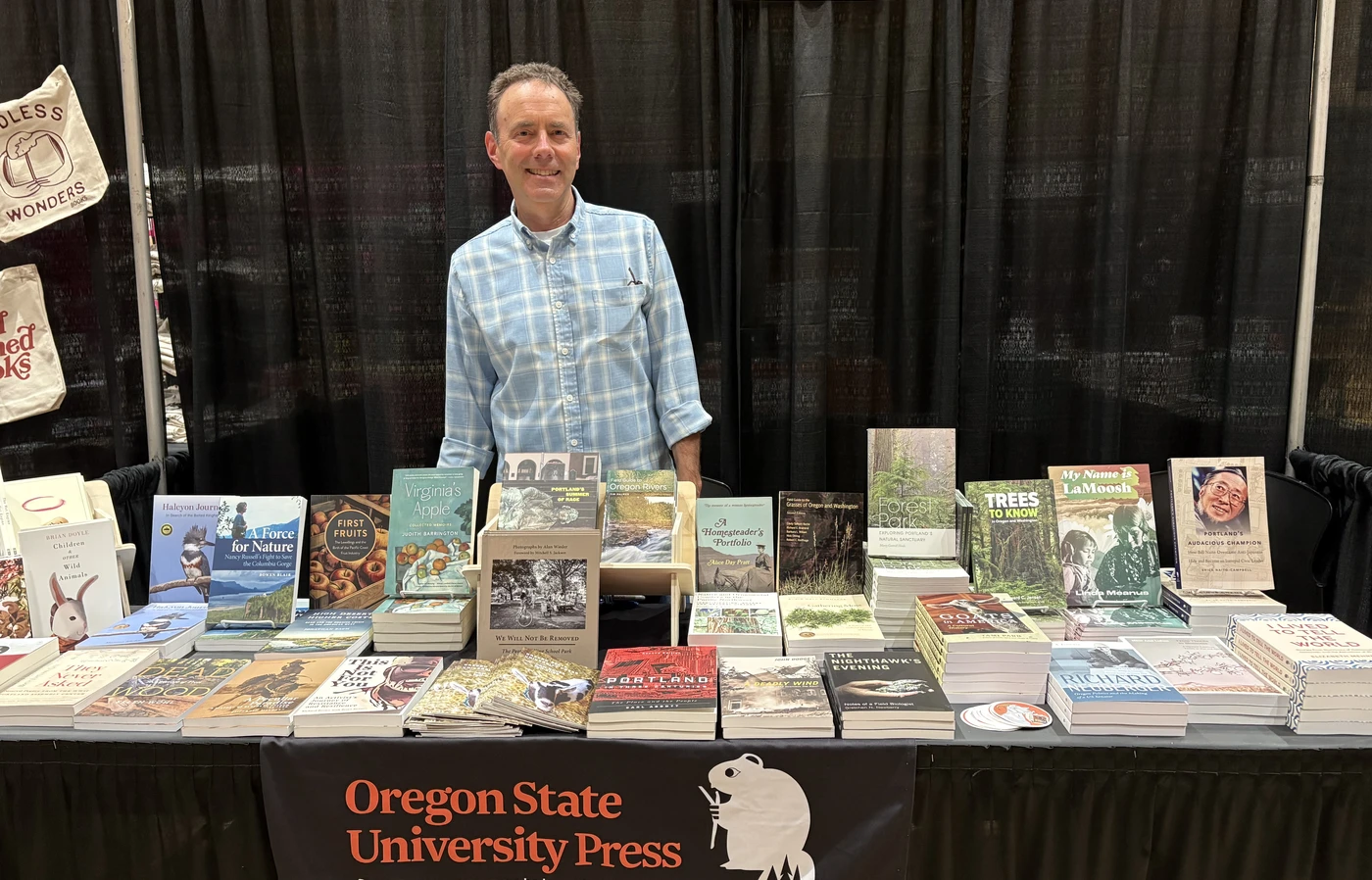 Man standing at book booth