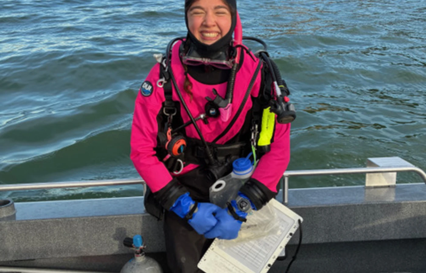 Woman smiling in boat with scuba gear