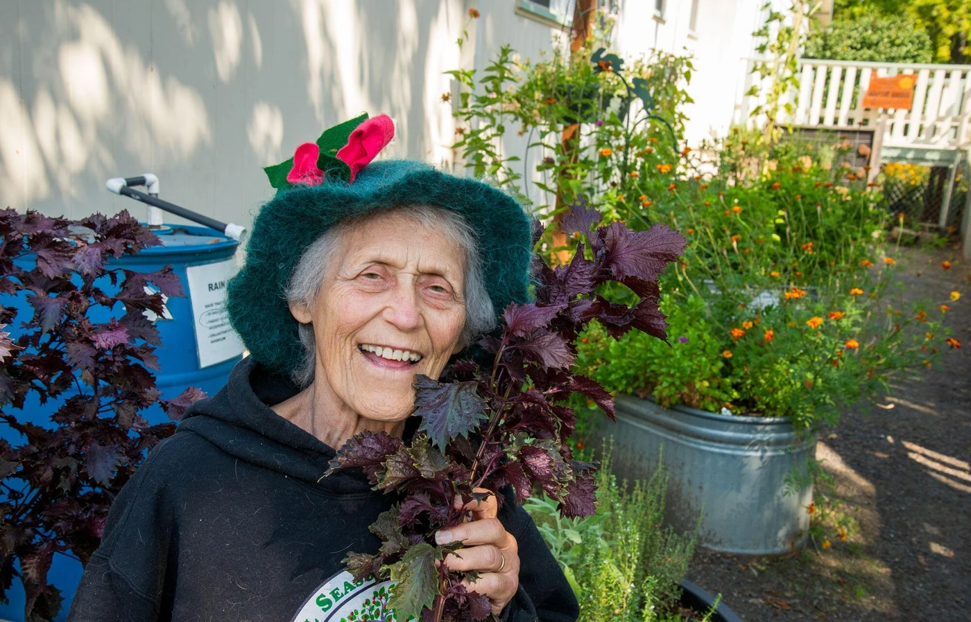 Woman in hat smiling in garden