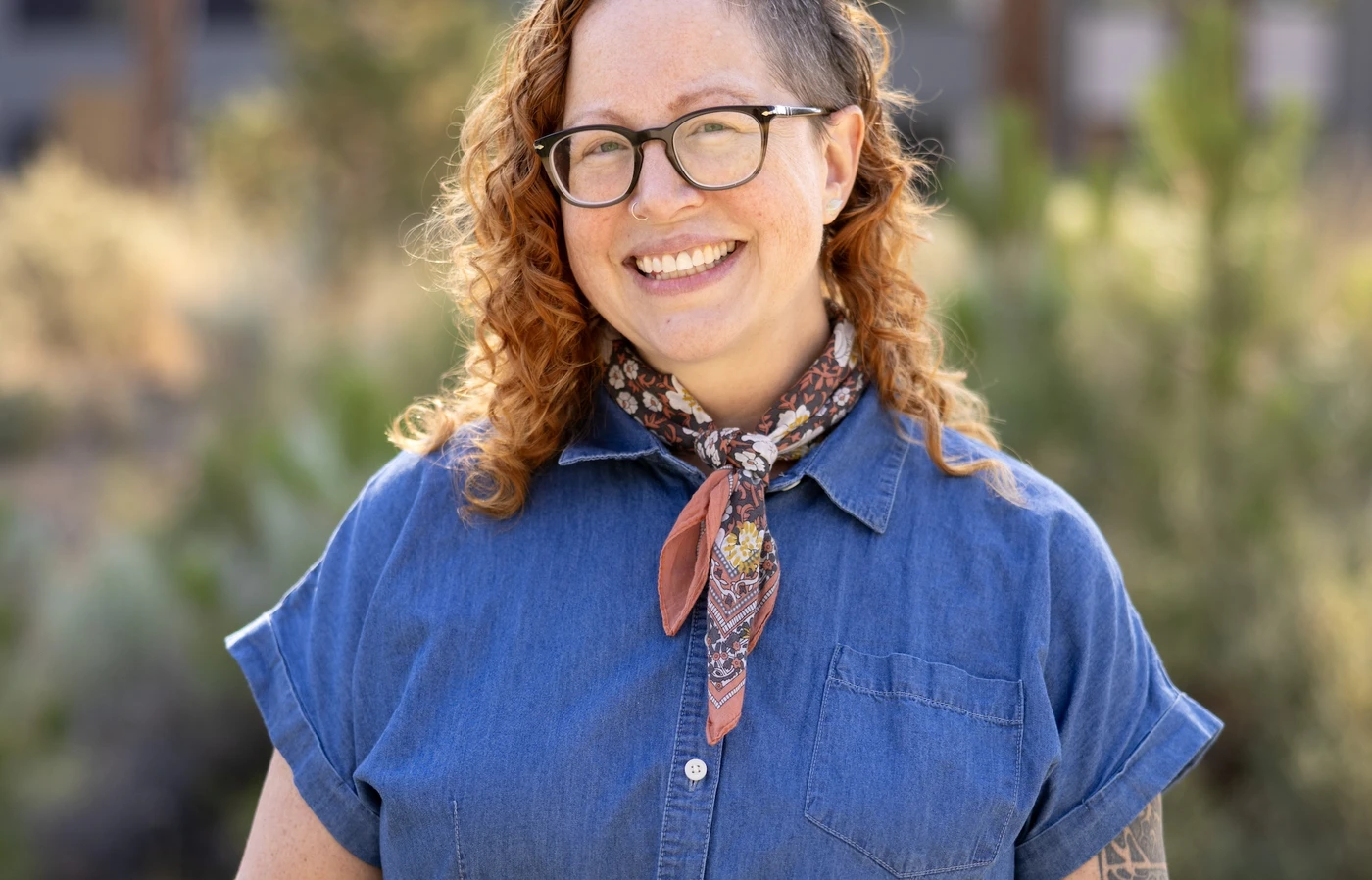 April Witteveen smiling outdoors.