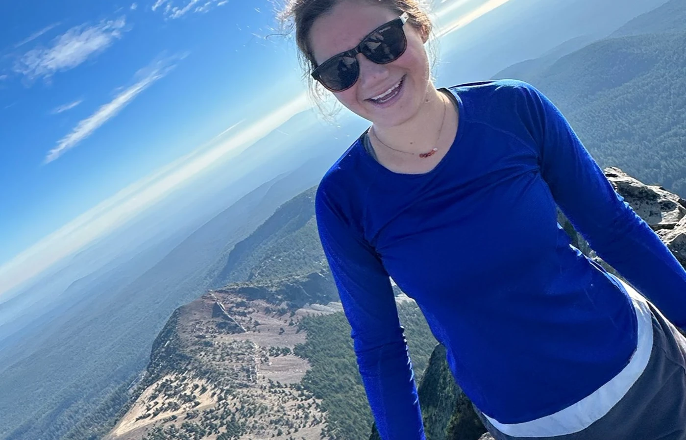 Riley Whisler posing at the top of Mount Thielsen in Oregon.