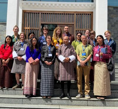 A group of OSU students pose on the steps of the Bhutanese capitol with the vice chancellor.