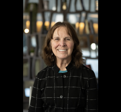 Headshot of Dr. Sue Tornquist in a dark-colored coat. 