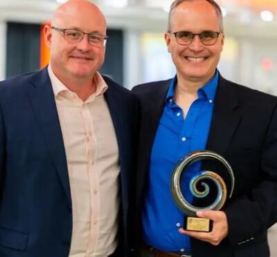 Men holding award