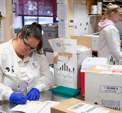 Lab technicians in white coats in the Oregon Veterinary Diagnostic Laboratory