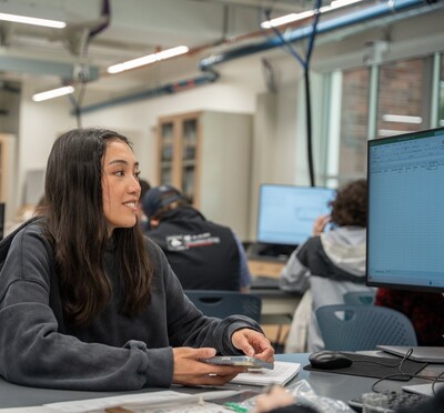Person sitting by computer monitor