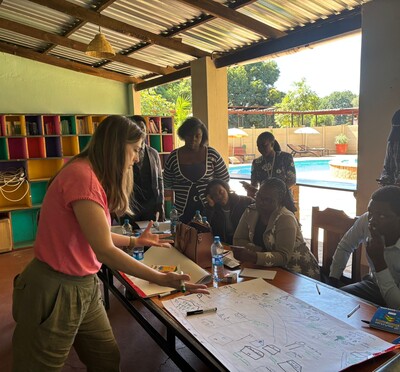 Laura Peters works with community members in a classroom in Zambia.