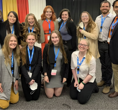 A group of students posing for a photo at an academic conference.