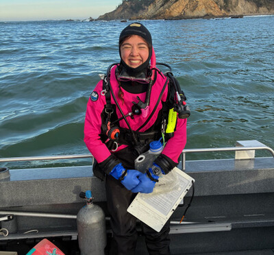 Woman smiling in boat with scuba gear