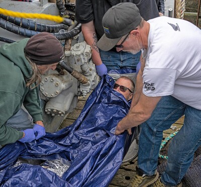 Commercial fishermen practice how to wrap a hypothermic patient and transport them to safety during a simulated first-aid training scenario aboard the fishing vessel Capt Ryan in Warrenton in 2023.