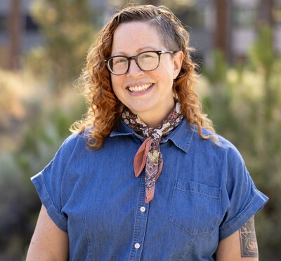 April Witteveen smiling outdoors.