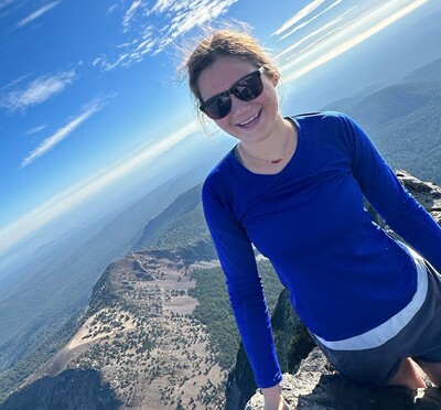 Riley Whisler posing at the top of Mount Thielsen in Oregon.