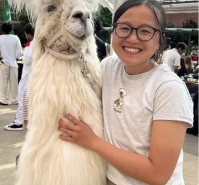 Woman smiling with white llama