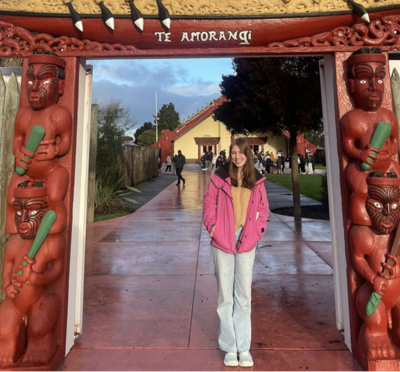 Yael Raich poses under a red Maori gate in New Zealand.