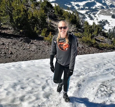 Woman standing on snow bank