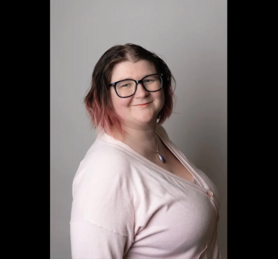 Misty Glenn in glasses and a pale pink sweater.