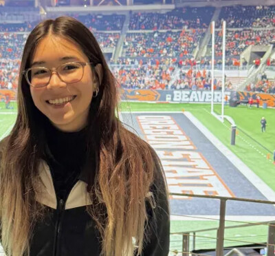 Susan Morgan posing in the stands in Reser Stadium.