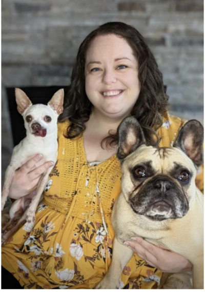Woman holding two dogs