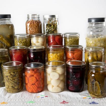 Canned vegetables are displayed on a table.