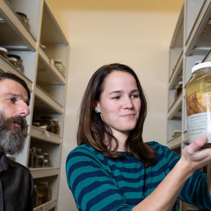 Peter Konstantinidis (left), Oregon State University instructor and curator of the Oregon State Ichthyology Collection, and student Kelci Pauk, look at a preserved whitefish