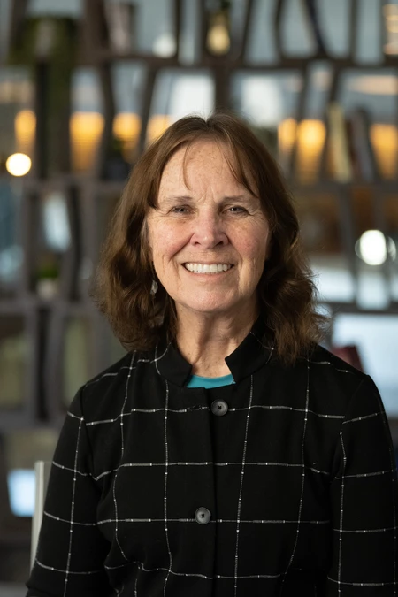 Headshot of Dr. Sue Tornquist in a dark-colored coat. 