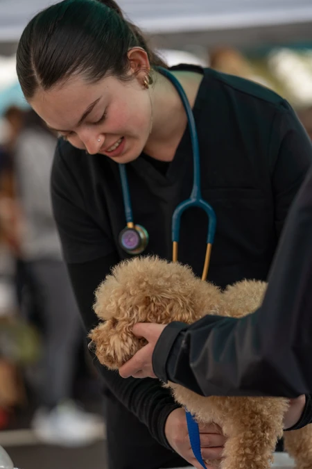 Student holding dog