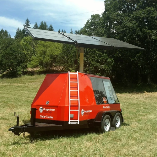 The Solar Trailer, a small red trailer with a large solar panel sticking out of the roof.