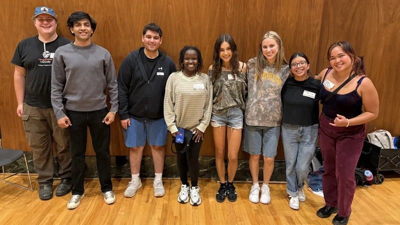 Group of students standing and smiling.