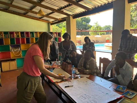 Laura Peters works with community members in a classroom in Zambia.