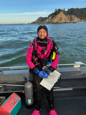 Woman smiling in boat with scuba gear