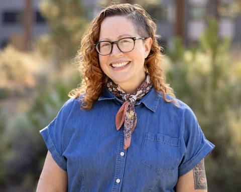 April Witteveen smiling outdoors.