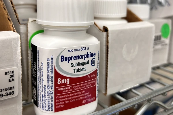 A white Buprenorphine pill bottle with a red and blue label.