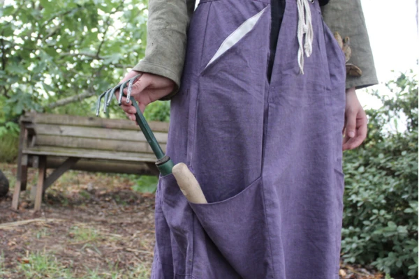 A model wears a flowy purple gardening skirt made as part of hemp textile project.