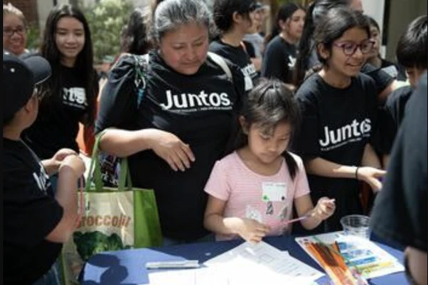 Adults and children wearing Juntos t-shirts; photo by Amanda Loman.
