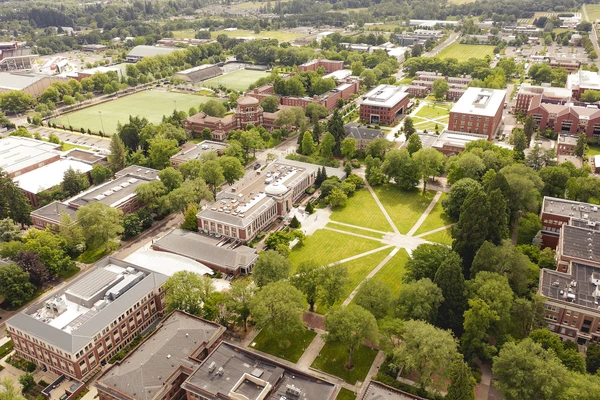 Aerial photo of OSU Corvallis campus, showing the quad with diagonal paths cutting through it to surrounding buildings.