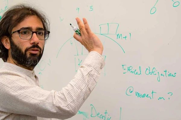 Portrait of faculty member at whiteboard