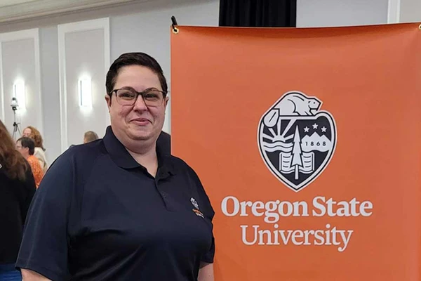 Person in front of OSU banner