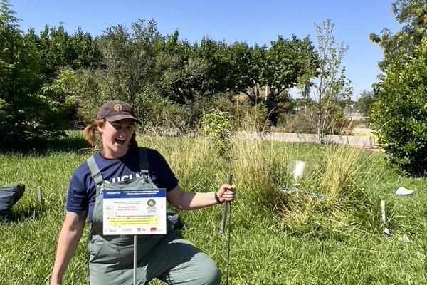 Forestry student Jill Aire poses enthusiastically in the field while doing soil recovery research in Spain.