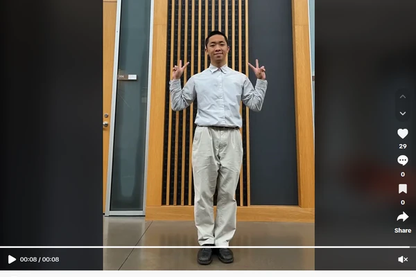 Student standing against wall