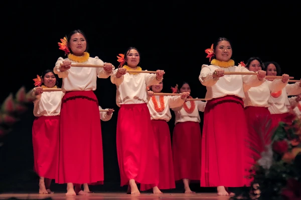 Group of Hawaiian dancers in red skirts