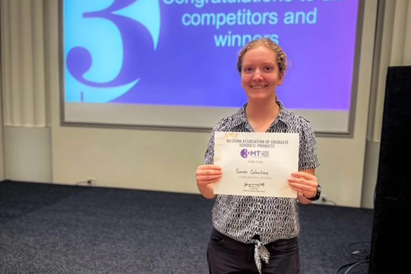 Student holding up award