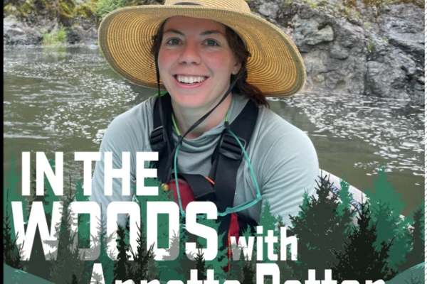 Woman in river wearing hat