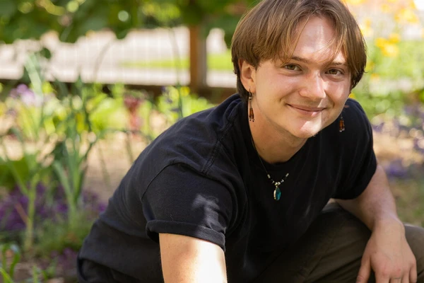 Milo Tisdale in a black shirt in the McNary Food Forest.