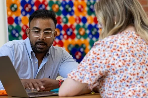 People sitting with a computer