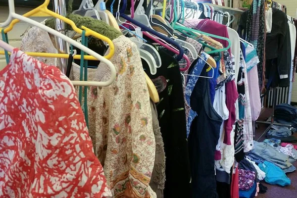 A messy rack of clothing on hangers.