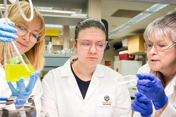 Researchers in the lab with beakers