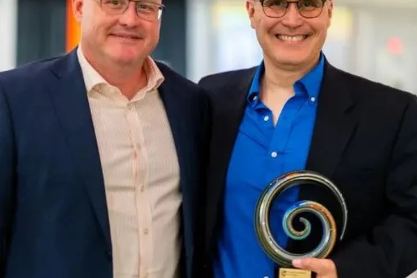Men holding award