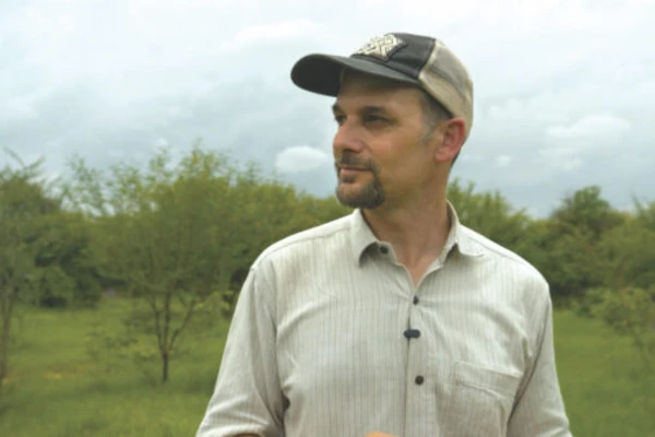 Andrew Millison wearing a baseball cap outdoors